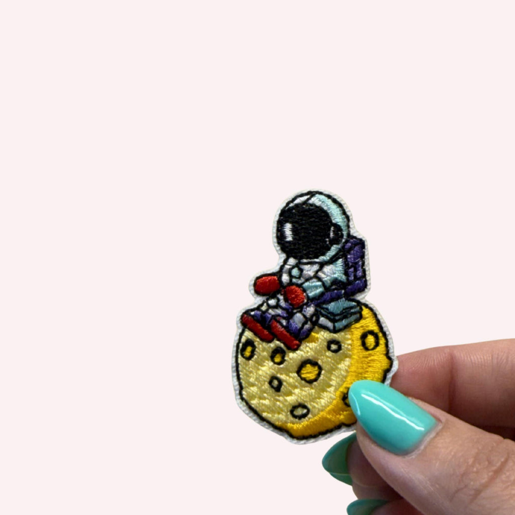 Astronaut Sitting on the Moon Iron-On Embroidery Patch (Approx. 2 inches)
